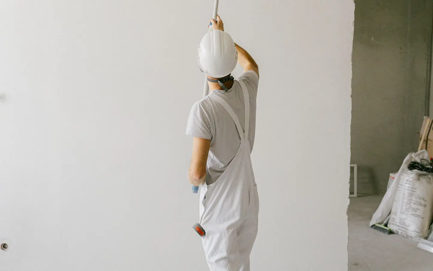 Painter rolling paint onto an interior wall